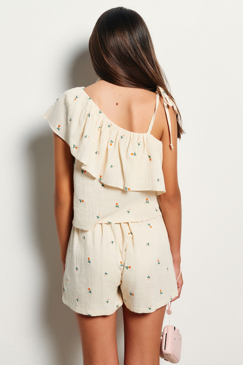 Blusa asimétrica volante bordado margaritas